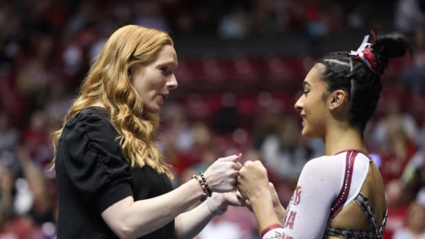 Alabama head coach Ashley Johnston fist bumps Alabama gymnast Luisa Blanco against Michigan State at Coleman Coliseum in Tuscaloosa, AL on Friday, Jan 6, 2023.
